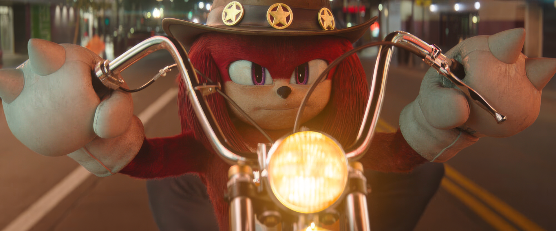 HD wallpaper featuring Knuckles the Echidna from the Sonic the Hedgehog series, riding a motorcycle at night with a lit headlamp and a focused expression.