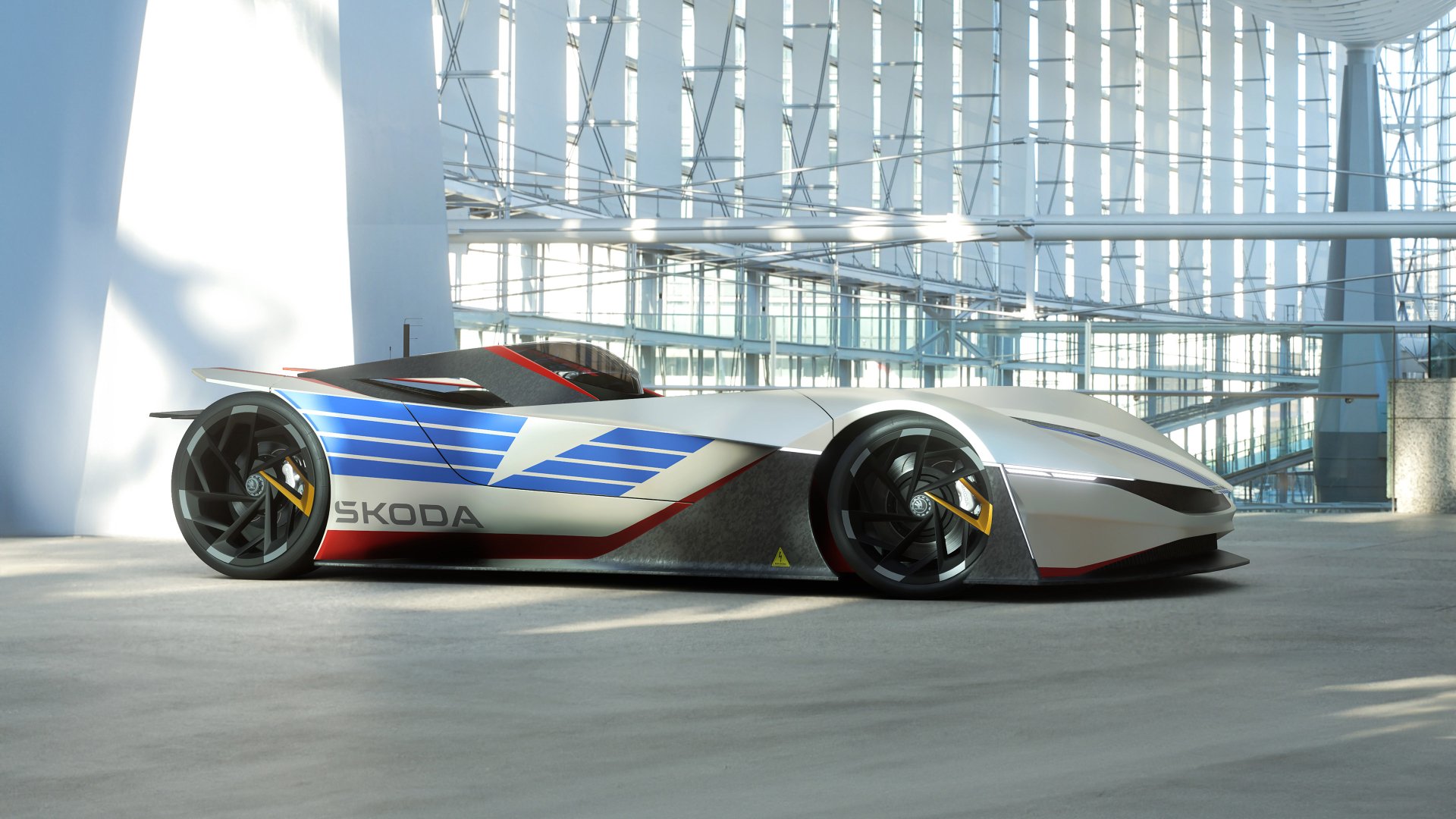 HD desktop wallpaper featuring the Skoda Vision GT concept car, displayed in a modern, glass-walled building.