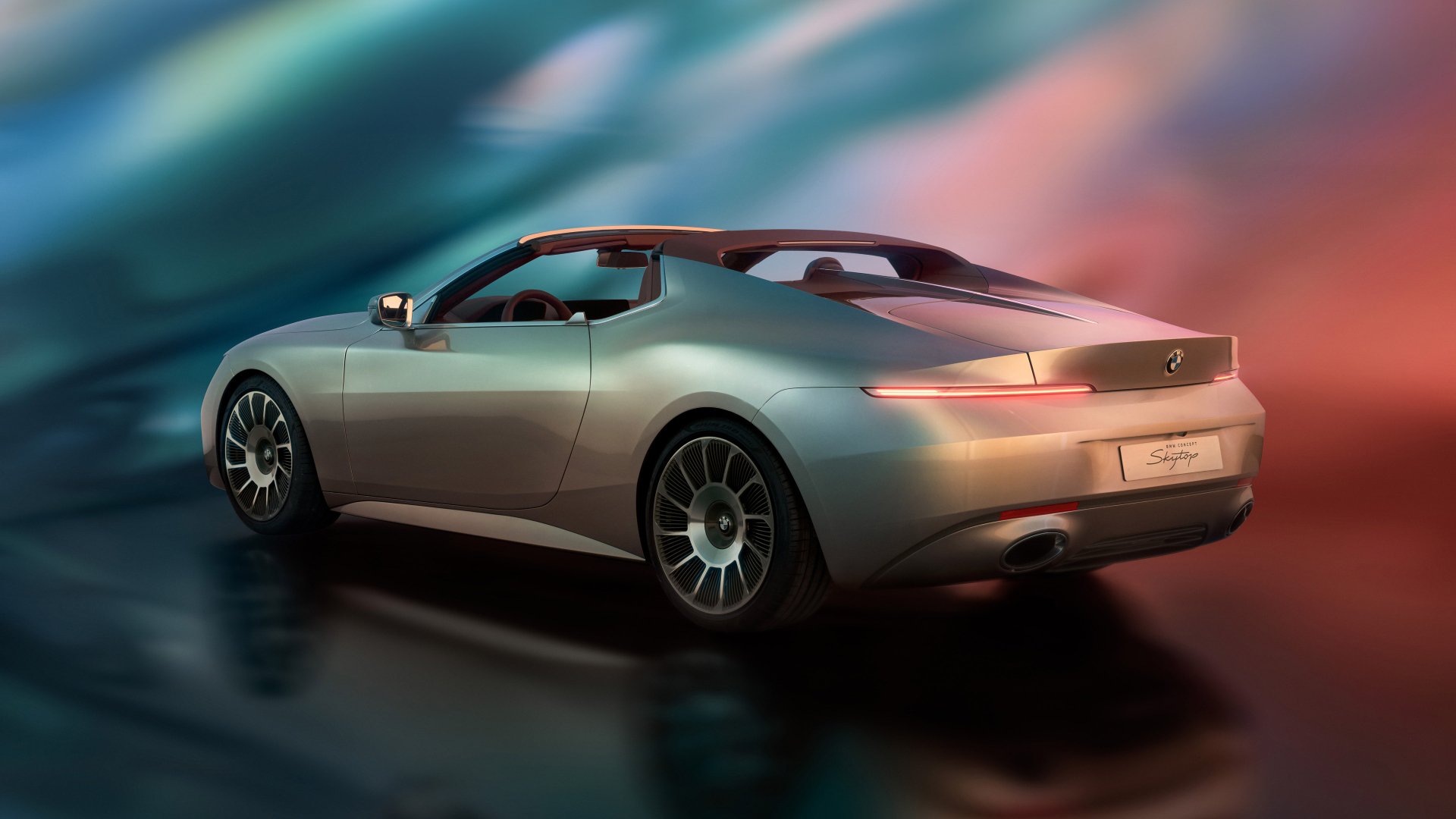 HD wallpaper of a sleek BMW Skytop, showcasing its modern design and smooth lines against a vibrant, blurred background.