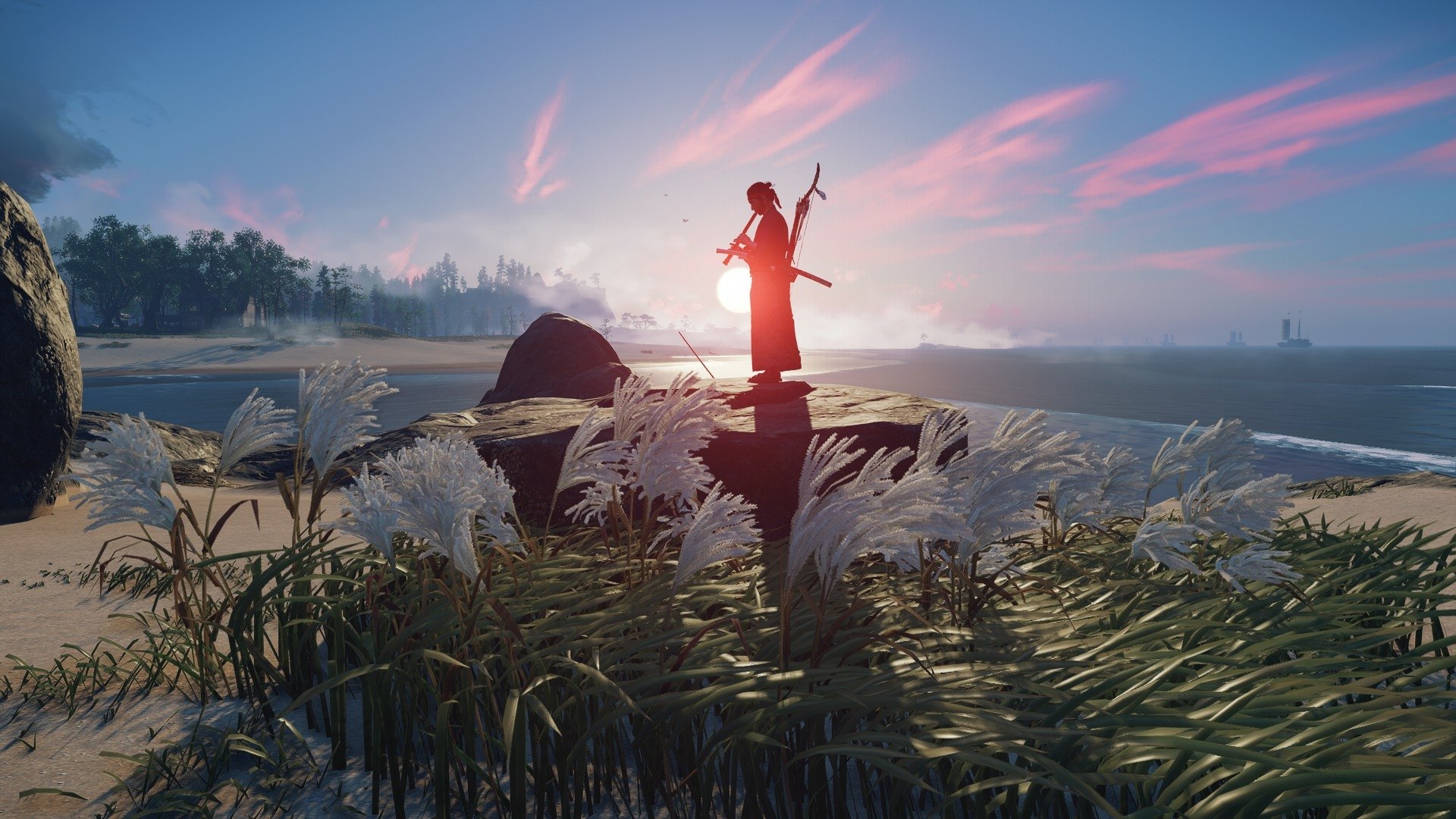 HD PC desktop wallpaper of Ghost of Tsushima featuring a lone samurai standing on a rock at sunset, surrounded by tall grasses and a serene coastal landscape.