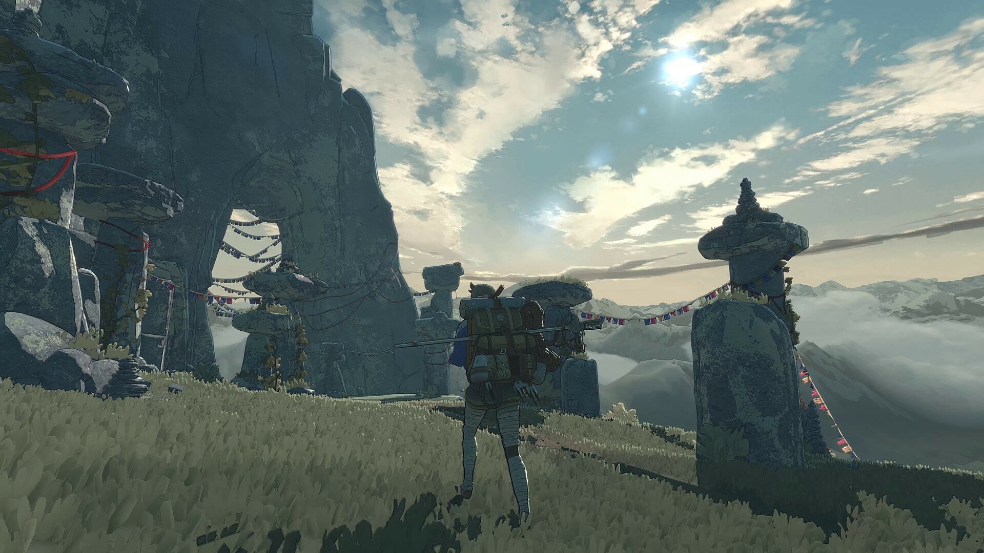 A high-definition desktop wallpaper featuring a video game scene with a character standing near a cairn set against a mountainous backdrop under a partly cloudy sky.