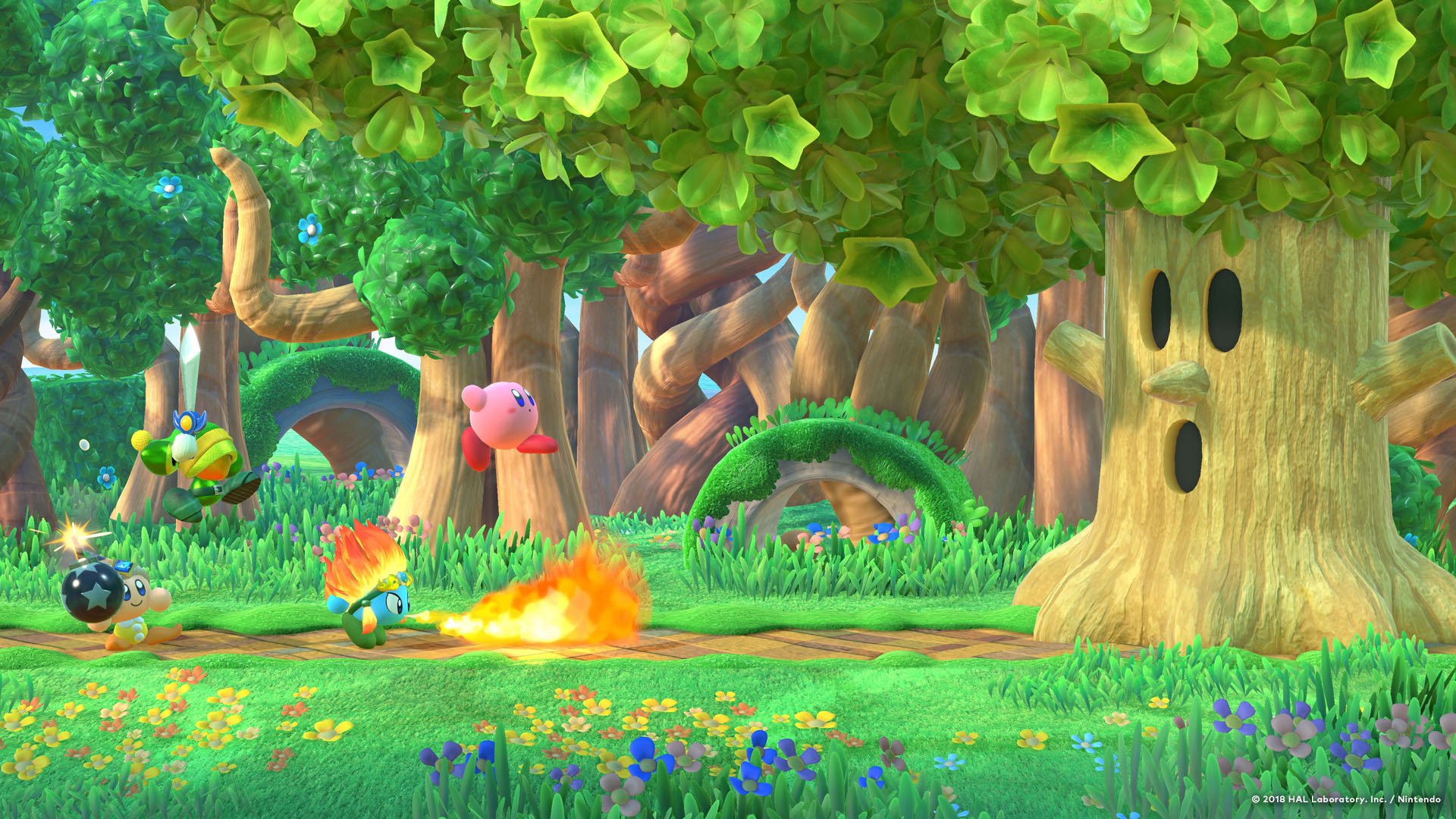HD PC desktop wallpaper featuring Kirby in a vibrant, lush forest setting with colorful flowers, animated trees, and playful characters from the Kirby universe.