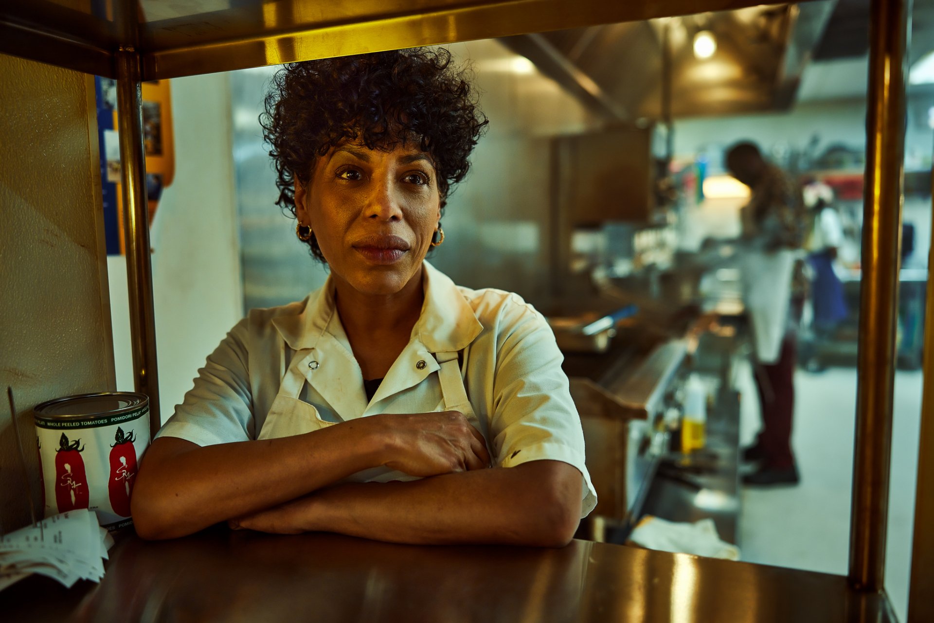 A scene from the TV show The Bear, featuring a chef standing in a bustling kitchen. This HD wallpaper and background showcases the intense atmosphere of a busy culinary environment.