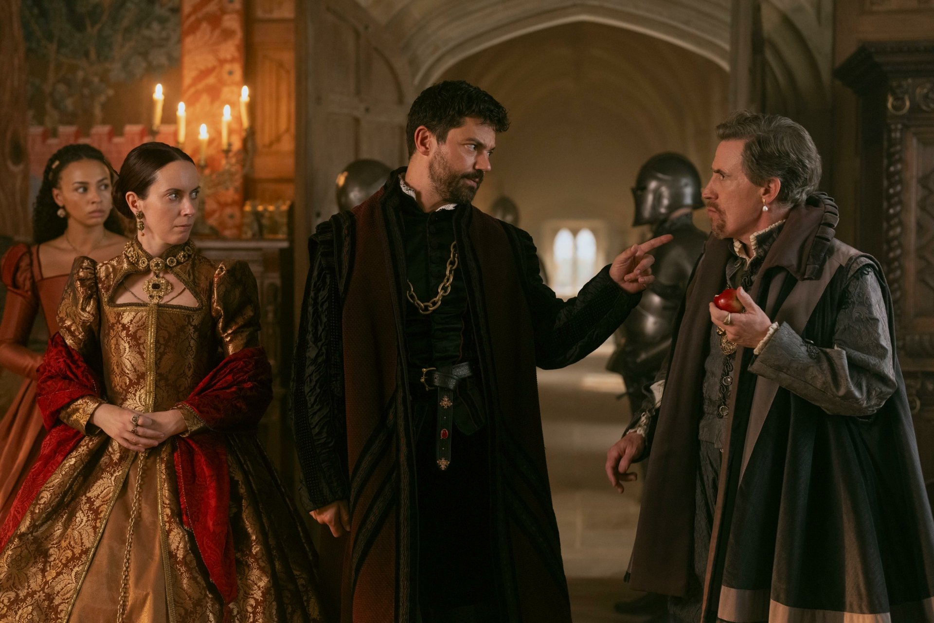 Scene from My Lady Jane showing characters in period costumes engaged in conversation, set in an opulent medieval hall. HDTV wallpaper and background.