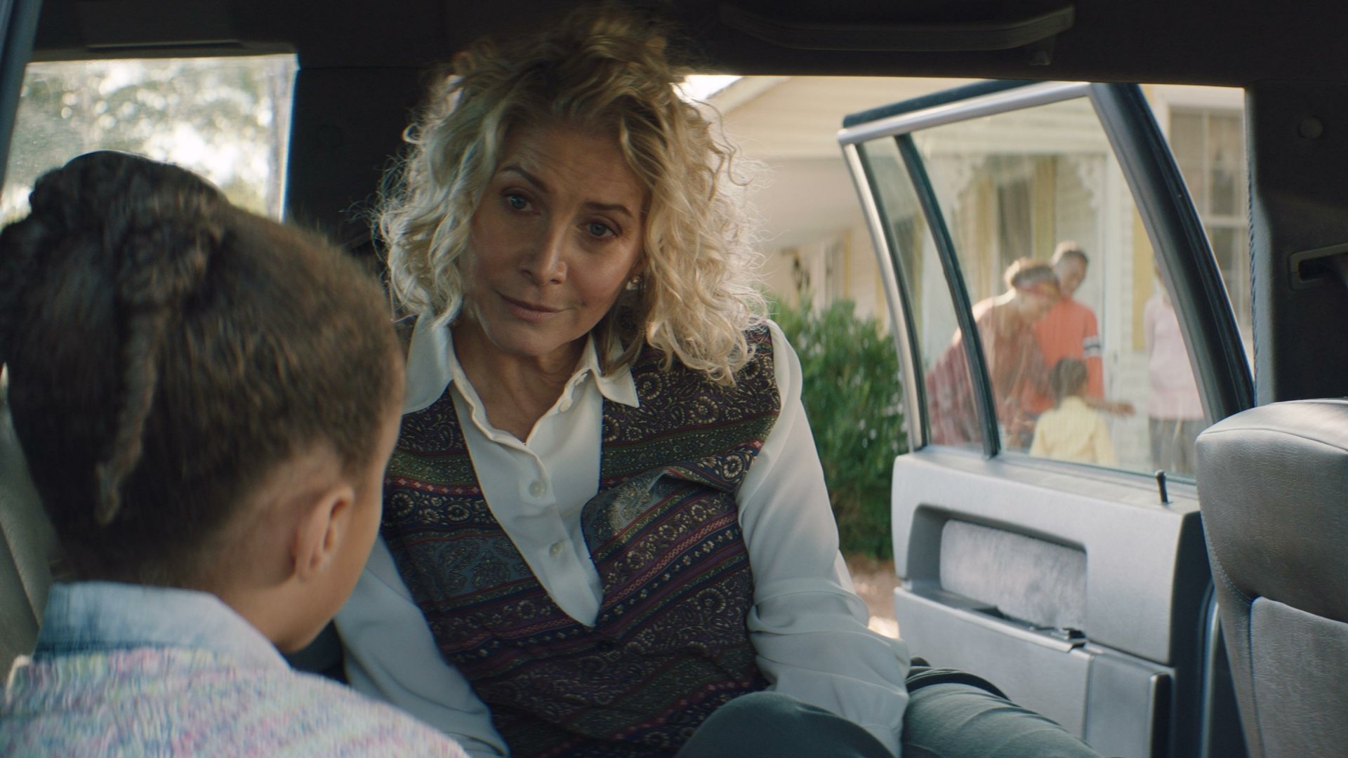 A scene from the movie Sound of Hope: The Story of Possum Trot showing two people having a conversation inside a car, with others in the background near a house. HD desktop wallpaper and background.