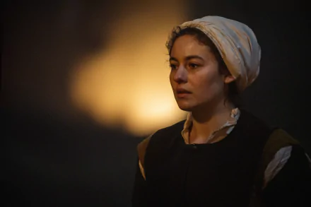 HD desktop wallpaper from the TV show Shardlake featuring a woman in historical garb with a headscarf, set against a softly lit background.