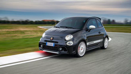 HD desktop wallpaper featuring a Fiat Abarth 695 Esseesse driving on a curved racetrack, with a scenic outdoor background.