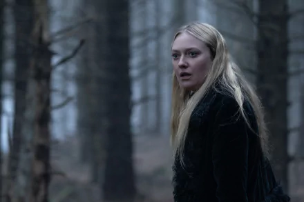 HD desktop wallpaper from the movie The Watchers (2024), featuring Dakota Fanning standing in a misty forest, looking surprised.