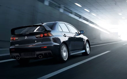 HD desktop wallpaper featuring a Mitsubishi Evolution X speeding through a tunnel.