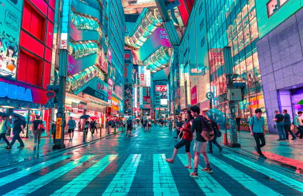 Colorful Tokyo street scene at night, featuring bright neon lights and bustling pedestrian activity. This HD desktop wallpaper captures the vibrant energy of Japan's capital city.