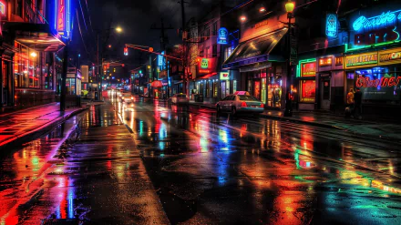 HD desktop wallpaper of a vibrant city street at night, featuring neon signs and wet, reflective pavement, captured in HDR detail.