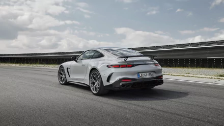 HD desktop wallpaper featuring a sleek Mercedes-AMG GT63 PRO on an open road under a partly cloudy sky.