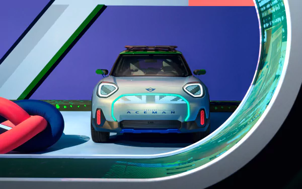 HD wallpaper of the MINI Aceman car presented in a colorful and stylized virtual environment, showcasing the vehicle's front view with a dynamic background.