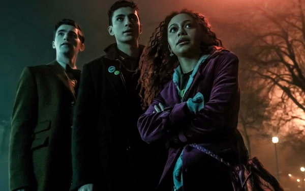 HD desktop wallpaper from the TV show Dead Boy Detectives, featuring three young detectives standing in a foggy, eerie environment.