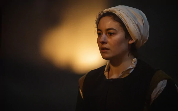 HD desktop wallpaper from the TV show Shardlake featuring a woman in historical garb with a headscarf, set against a softly lit background.