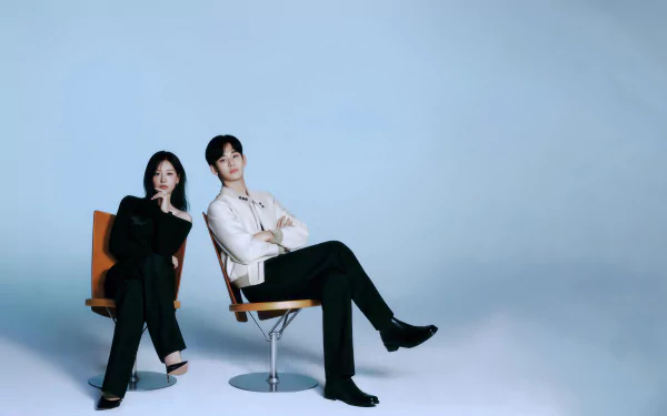 HD wallpaper of two actors from the TV show Queen of Tears, posing confidently on chairs against a blue background.