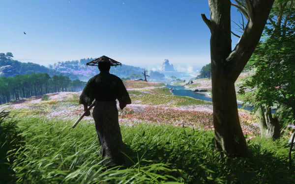 HD desktop wallpaper from the video game Ghost of Tsushima, featuring a samurai overlooking a scenic, flower-filled landscape.