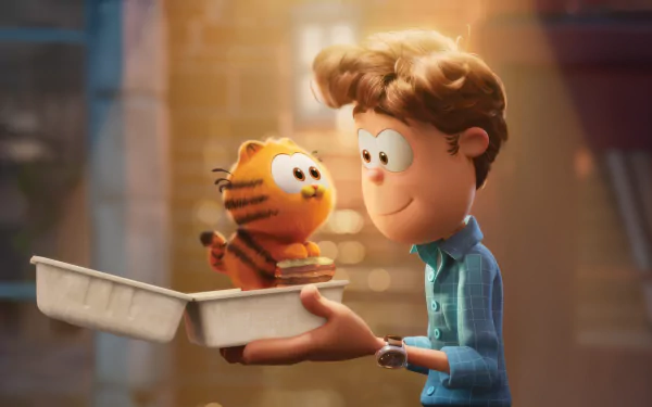 HD desktop wallpaper from The Garfield Movie featuring Garfield and a young boy smiling at each other outdoors.