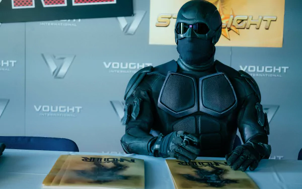 HD desktop wallpaper of Black Noir from the TV show The Boys (2019) signed autographs at a Vought International event.
