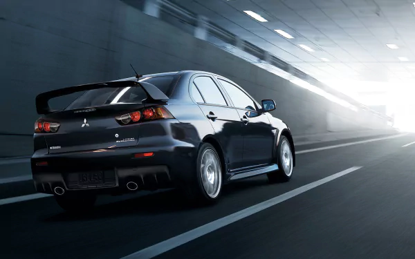 HD desktop wallpaper featuring a Mitsubishi Evolution X speeding through a tunnel.
