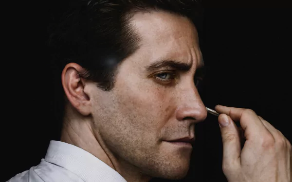 HD wallpaper showing Jake Gyllenhaal in character for the TV show Presumed Innocent (2024). The close-up profile shot highlights his intense expression.