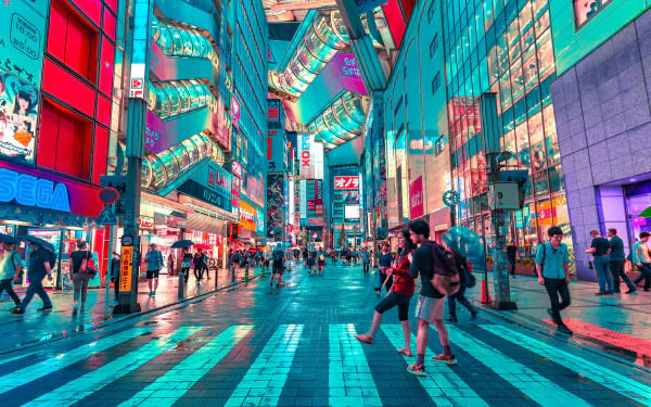 Colorful Tokyo street scene at night, featuring bright neon lights and bustling pedestrian activity. This HD desktop wallpaper captures the vibrant energy of Japan's capital city.