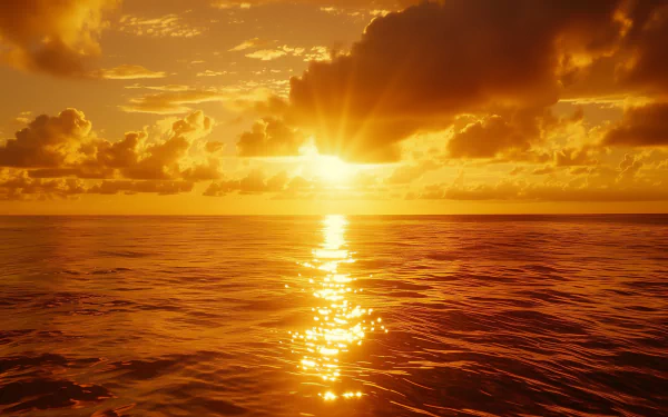 HD desktop wallpaper of a serene ocean sunset, with golden sunlight reflecting off the water and dramatic clouds in the sky.