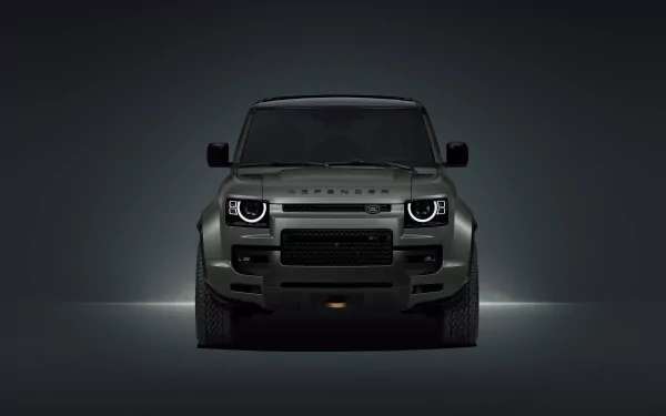 HD desktop wallpaper of a Land Rover Defender Octa vehicle showcasing its robust front view. The image captures the sleek and powerful design of the car against a dark background.
