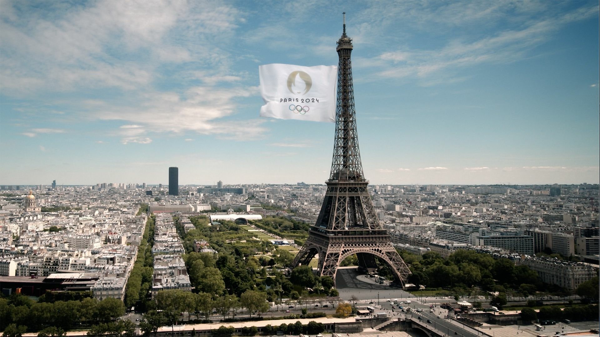 An HD desktop wallpaper featuring the Eiffel Tower, celebrating the Olympic Games Paris 2024, showcasing the vibrant spirit of sports in France.
