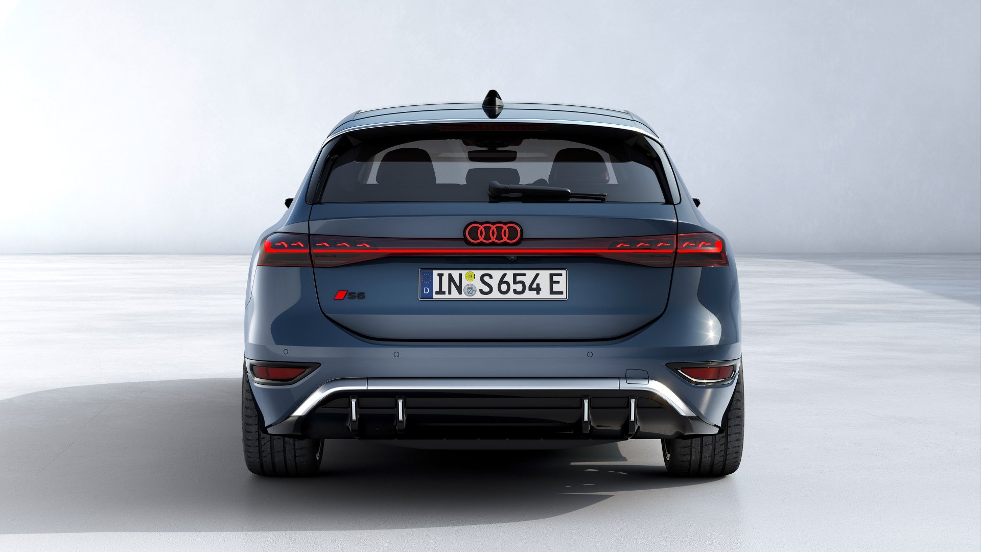 A sleek Audi S6 E-Tron showcased from the rear, featuring modern design elements and a striking color scheme, set against a clean, minimalist background. HD desktop wallpaper.