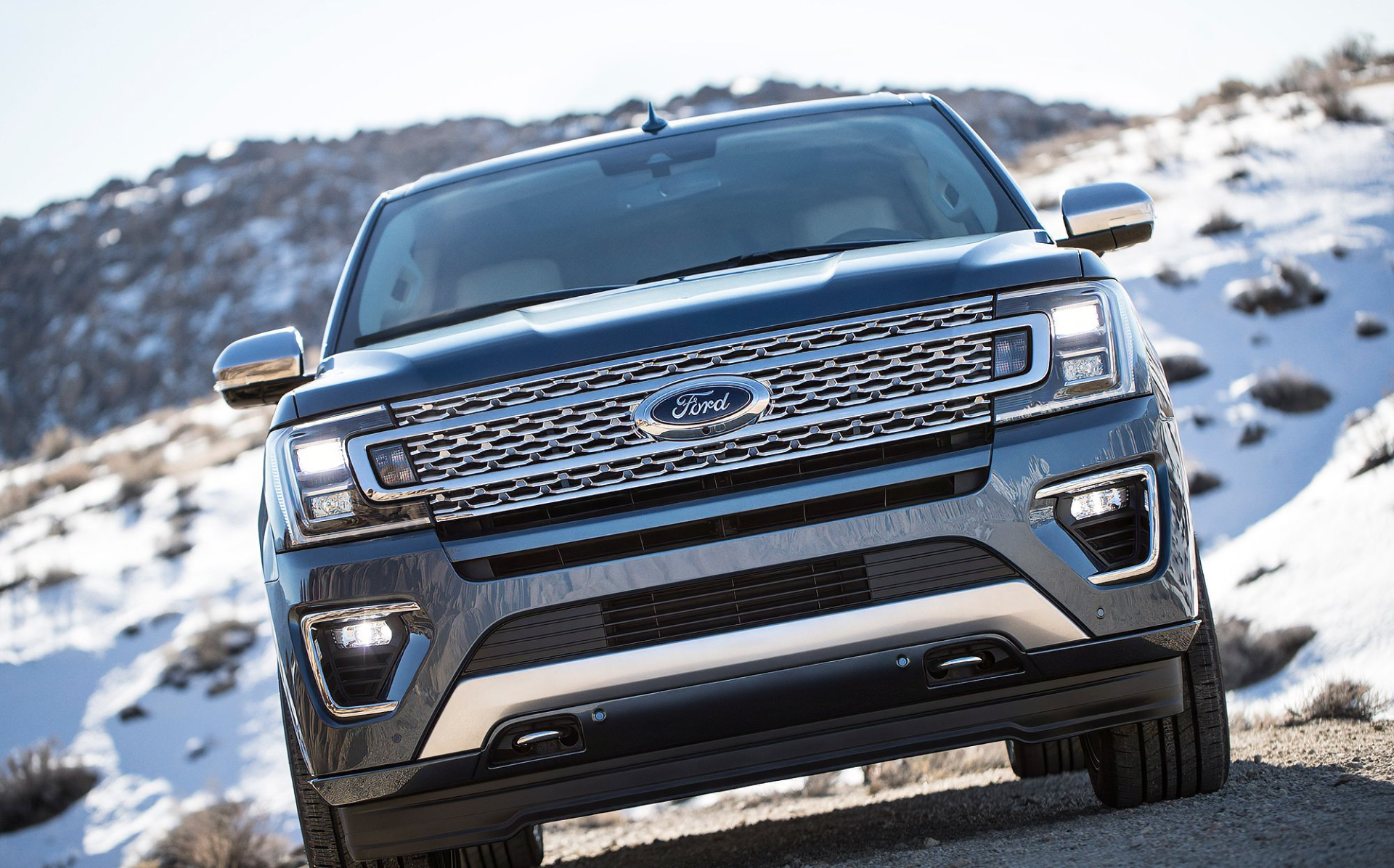 A sleek Ford Expedition commands attention in this HD desktop wallpaper, showcasing its bold design against a rugged, snowy landscape.