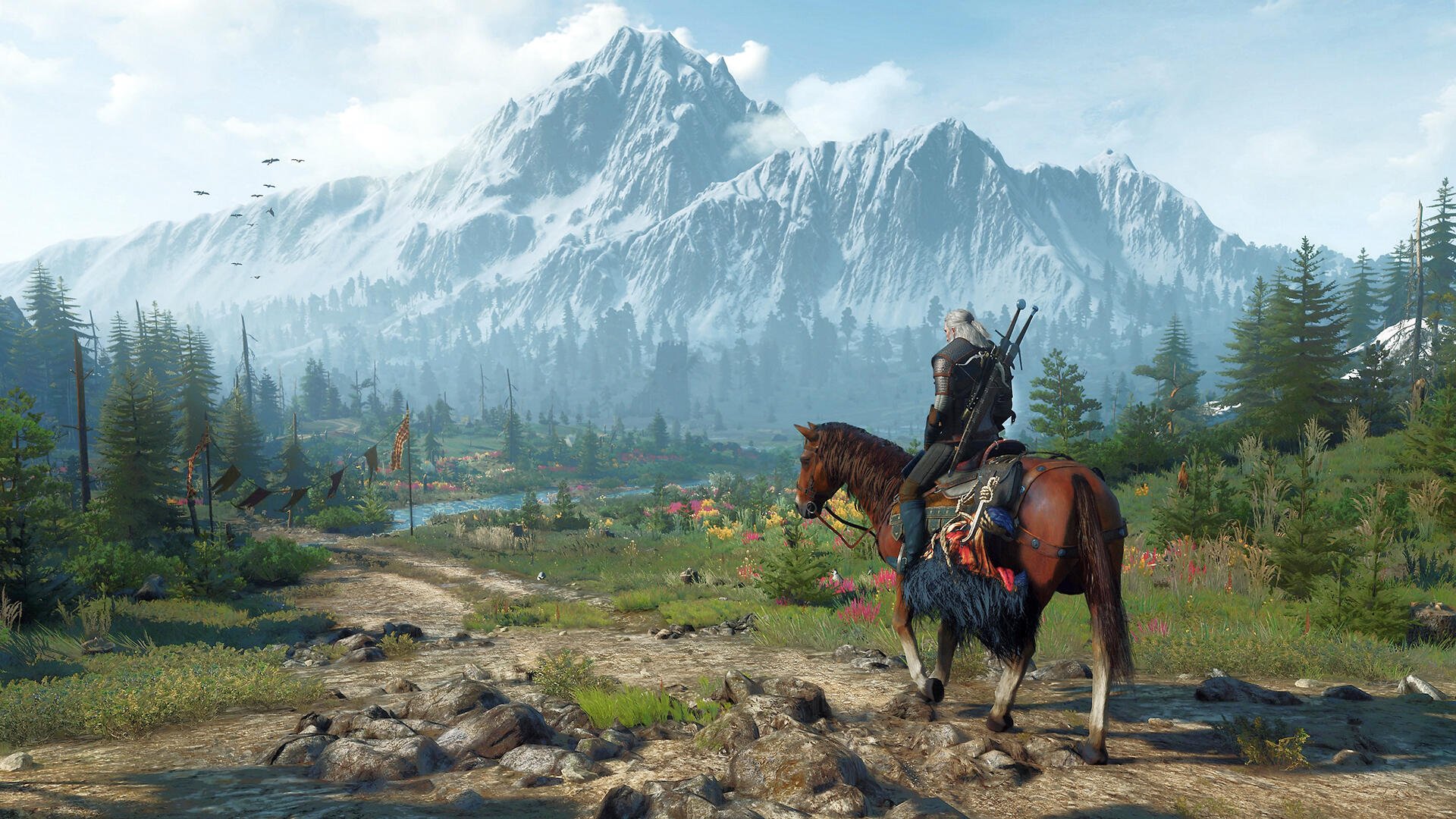The Witcher 3: Wild Hunt HD PC desktop wallpaper — Geralt on horseback overlooking a grassy valley with flowers, pine forest and snow-capped mountains under a bright sky.
