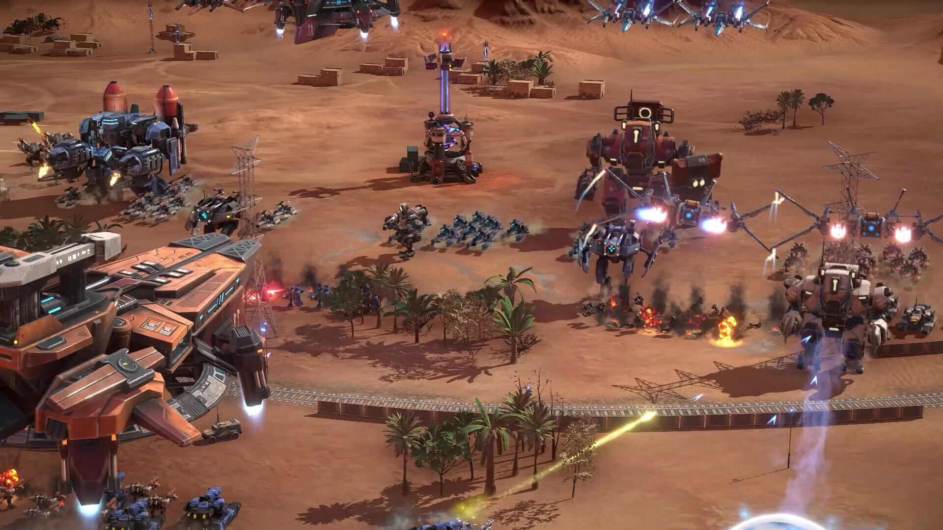 A high-definition desktop wallpaper from the video game Mechabellum, showcasing an intense battle scene with futuristic machines and vibrant explosions on a barren landscape.