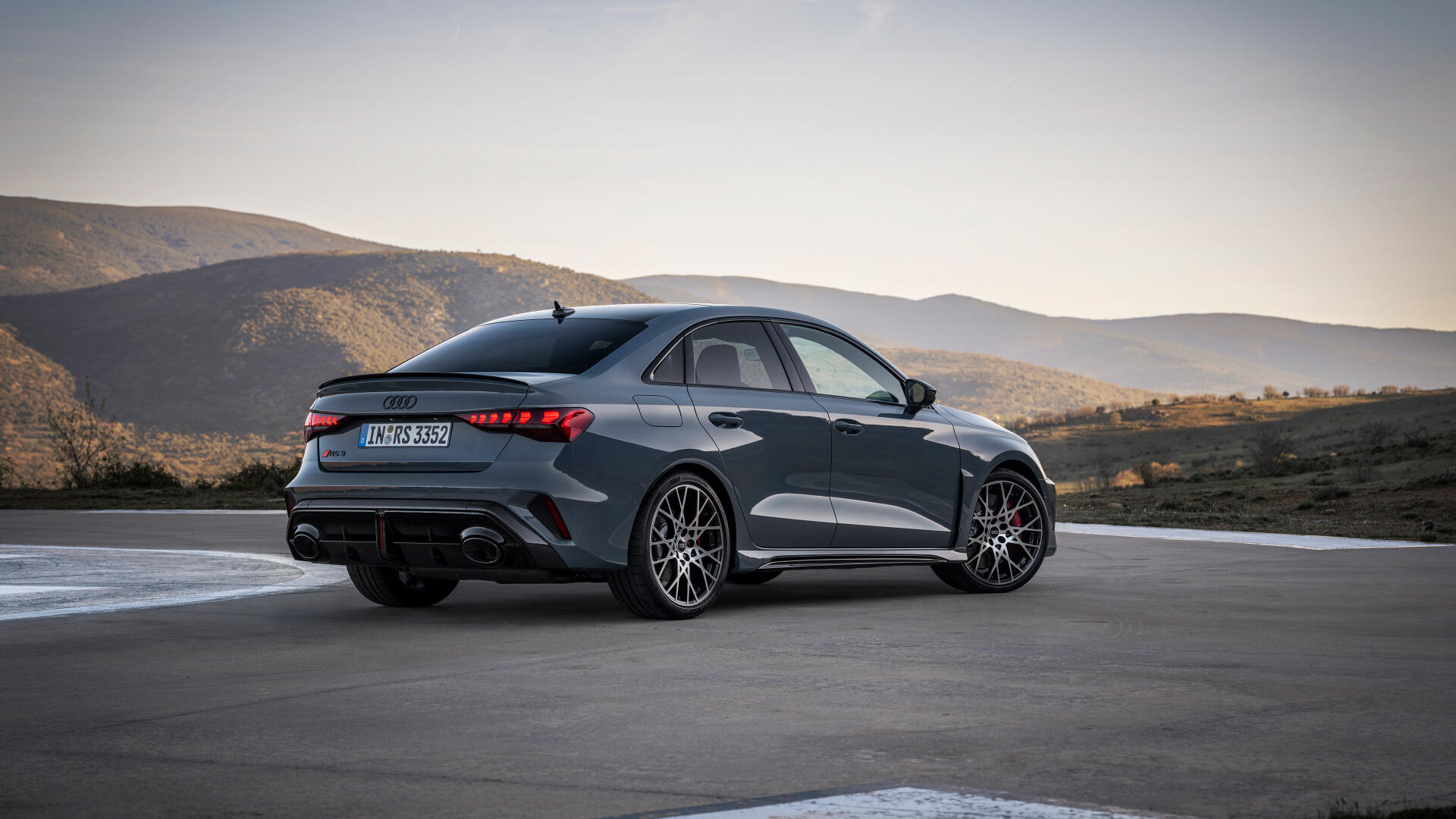 Audi RS3 Sedan parked against a scenic backdrop, showcasing its sleek design and performance features. This stunning image serves as a 4K Ultra HD desktop wallpaper.