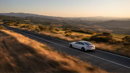 A sleek Porsche Panamera Turbo S E-Hybrid displayed in a striking HD desktop wallpaper, showcasing its elegant design and powerful stance.