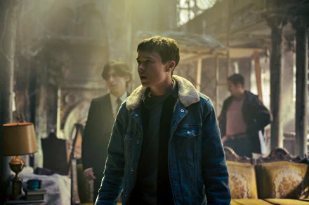 A high-definition wallpaper from The Umbrella Academy, featuring a tense scene with a young man in a denim jacket and two others in a dimly lit, seemingly abandoned room.