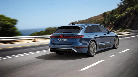 A striking Audi S6 E-Tron drives along a scenic road, showcasing its sleek design against a backdrop of hills and ocean, captured in stunning 4K Ultra HD quality.