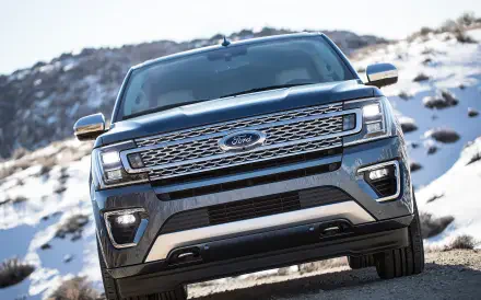 A sleek Ford Expedition commands attention in this HD desktop wallpaper, showcasing its bold design against a rugged, snowy landscape.