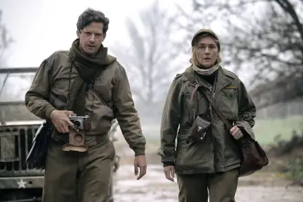A scene from the movie Lee (2023) featuring Kate Winslet and Andy Samberg walking together in military attire, captured in a 4K Ultra HD wallpaper.