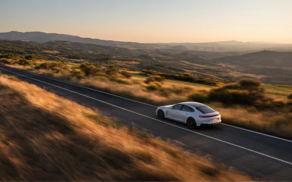 A sleek Porsche Panamera Turbo S E-Hybrid displayed in a striking HD desktop wallpaper, showcasing its elegant design and powerful stance.