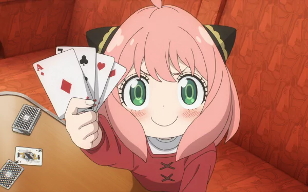 Anya Forger from Spy x Family Code: White holding playing cards with a confident smile, featured in a vibrant HD anime desktop wallpaper.
