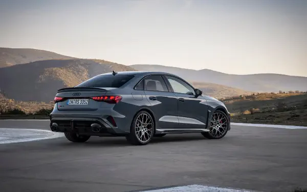 Audi RS3 Sedan parked against a scenic backdrop, showcasing its sleek design and performance features. This stunning image serves as a 4K Ultra HD desktop wallpaper.