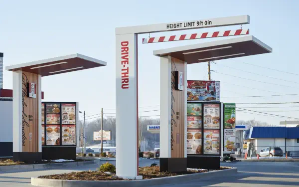 A vibrant HD desktop wallpaper featuring a KFC drive-thru, showcasing the menu boards and a height limit sign in a bright, clear setting.