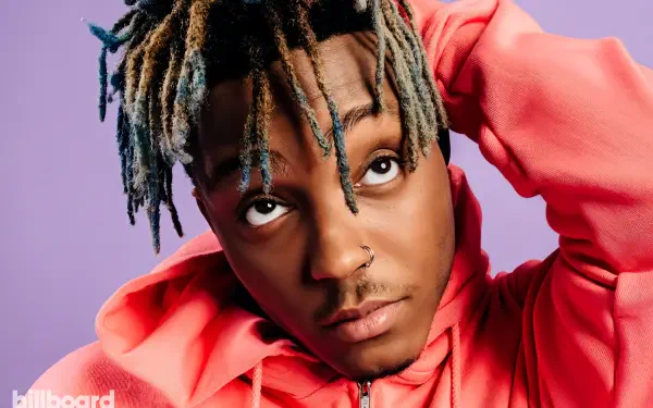 Juice Wrld, an influential rapper, is portrayed in this vibrant HD desktop wallpaper, showcasing his distinctive style and captivating expression against a colorful background.