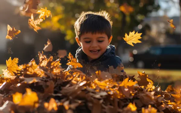A cheerful child plays in a vibrant pile of autumn leaves, with golden leaves swirling around him, captured in a stunning 4K Ultra HD background.