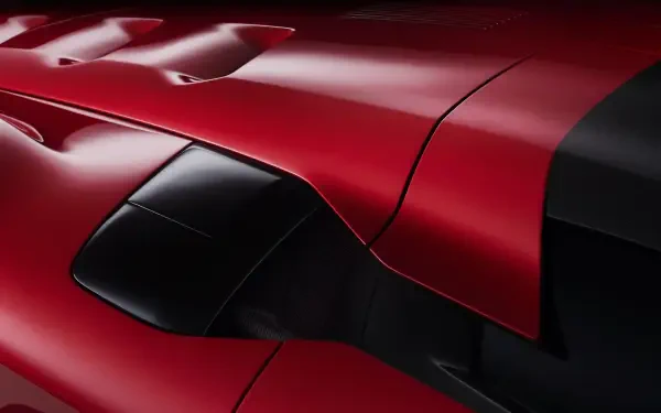 Close-up 4K Ultra HD wallpaper of a sleek red Ferrari F80 showcasing its aerodynamic design and glossy finish.