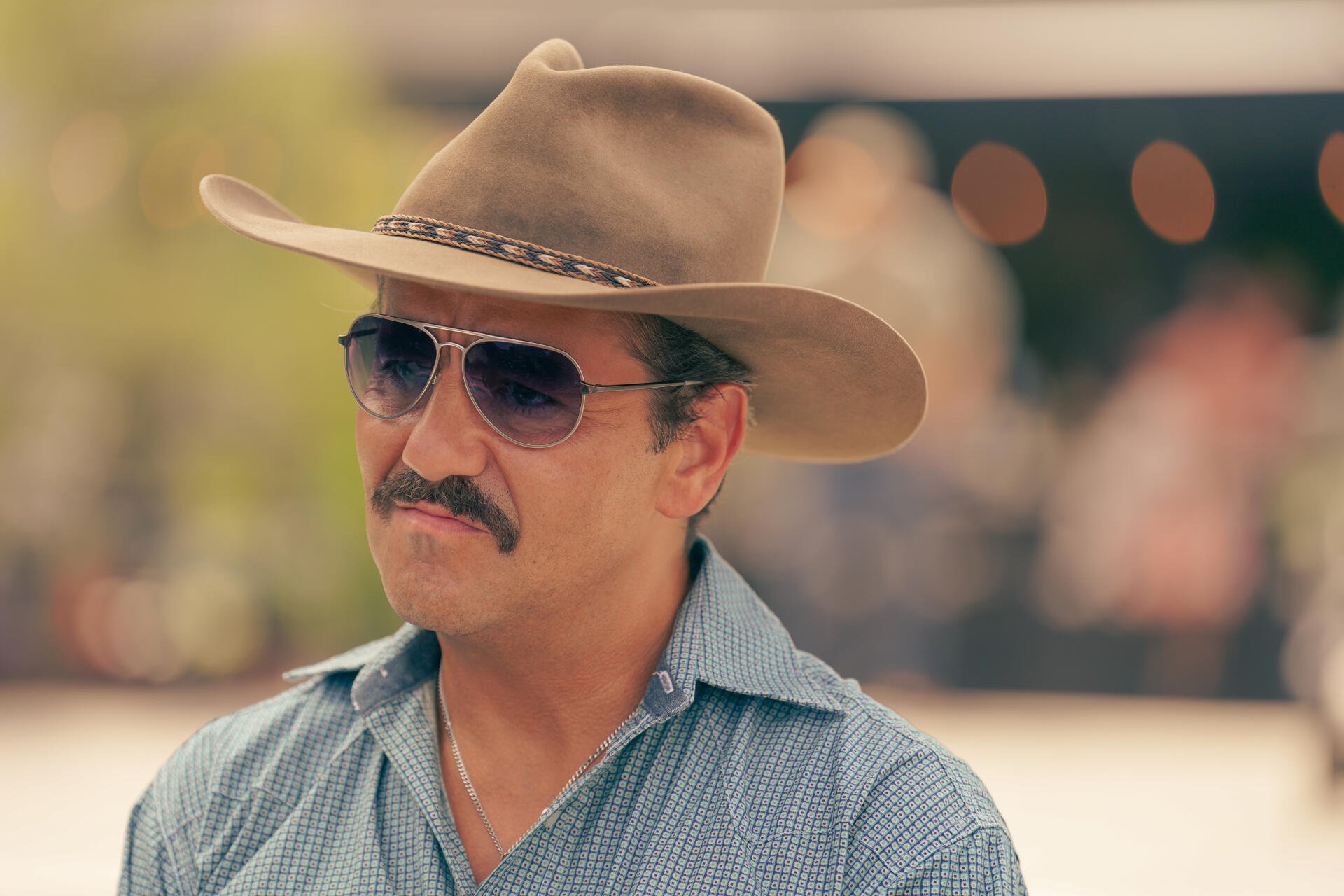 A character from the TV show Tulsa King wearing a cowboy hat and sunglasses, captured in a vibrant 4K Ultra HD setting, showcasing a distinctive style.