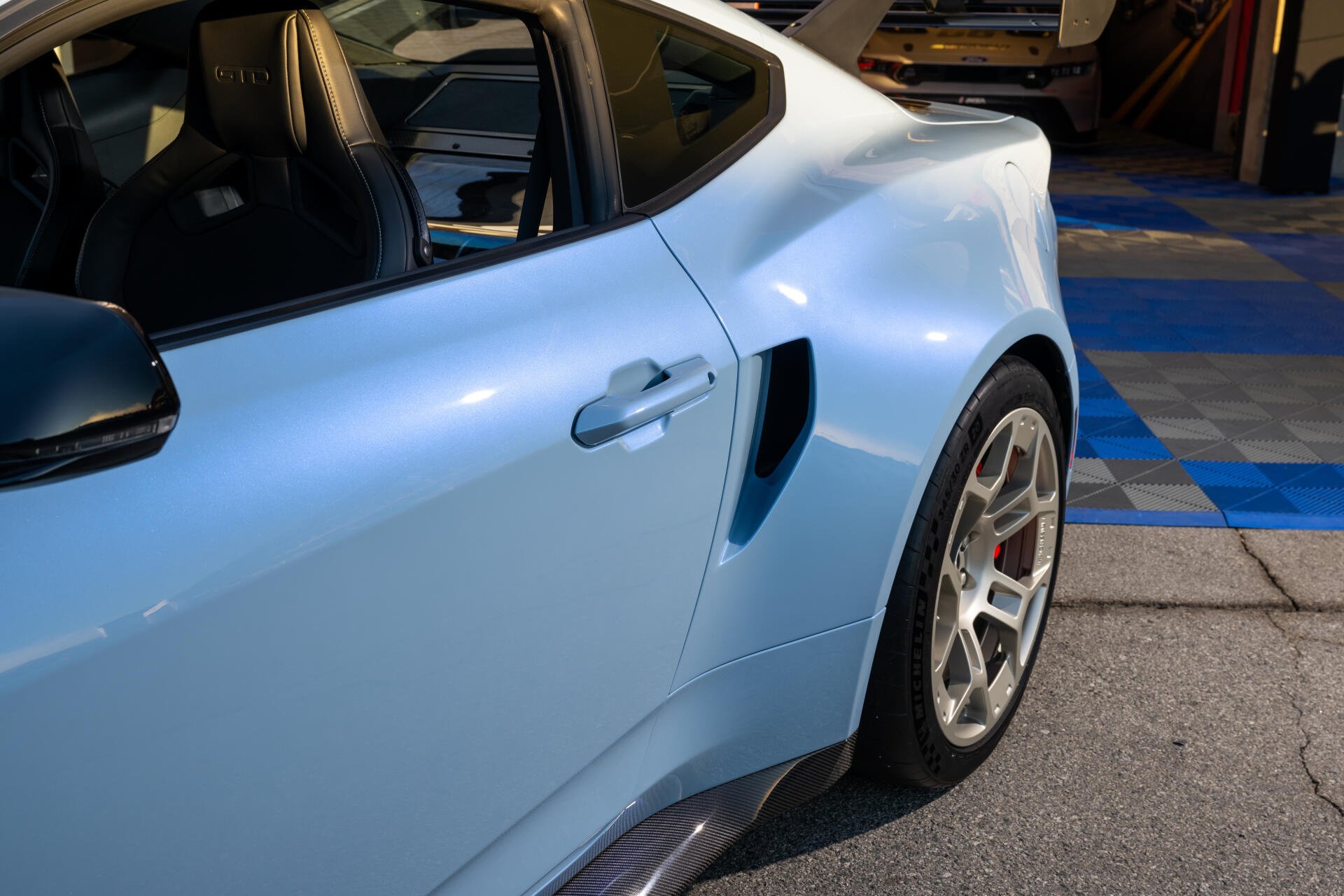 Close-up of a Ford Mustang GTD showcasing its sleek design and unique features. The image is an 8K Ultra HD PC wallpaper, offering stunning detail for car enthusiasts.