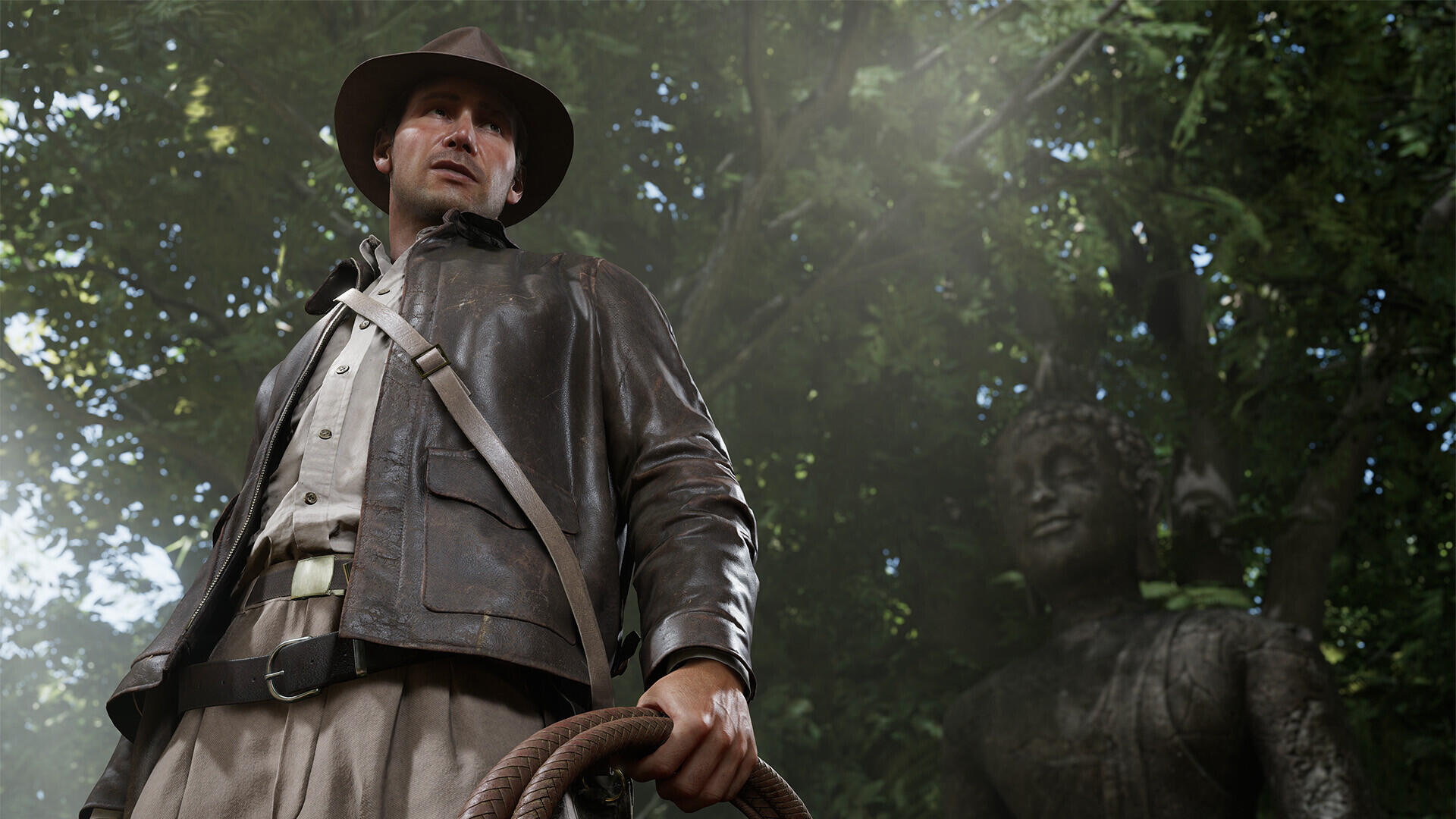 An HD PC desktop wallpaper featuring Indiana Jones from Indiana Jones and the Great Circle, standing confidently with a whip, surrounded by a misty, mysterious forest ambiance.