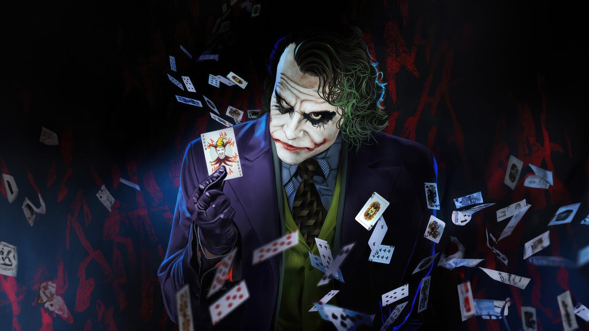 HD PC desktop wallpaper featuring the Joker holding a card, surrounded by flying playing cards in a dark, dramatic setting.